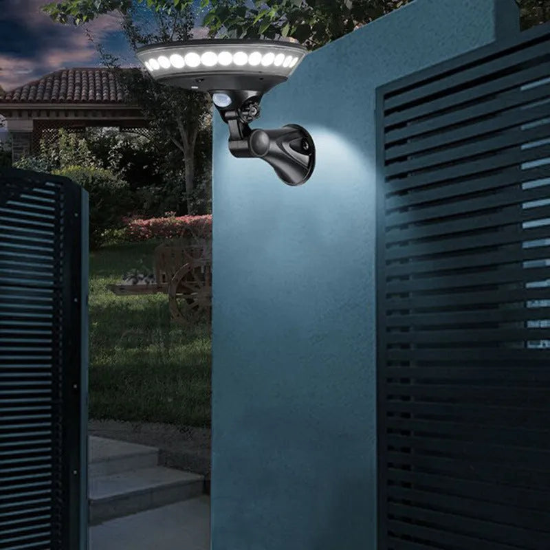 White 360-degree solar garden security light with motion sensor on a stake for outdoor installation.