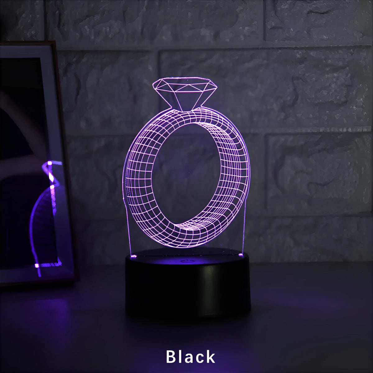 3D diamond ring design LED night light with colour changing modes on a black background.