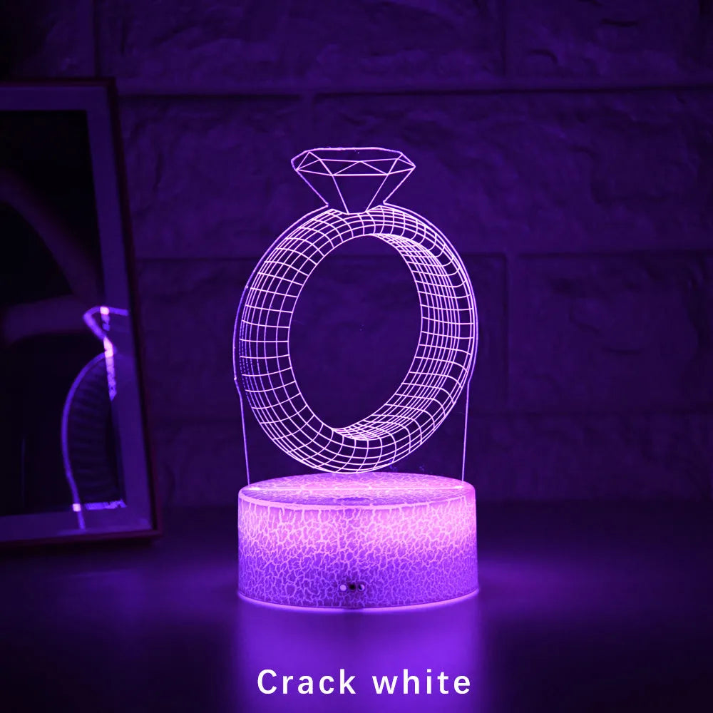 3D diamond ring design LED night light with colour changing modes on a black background.