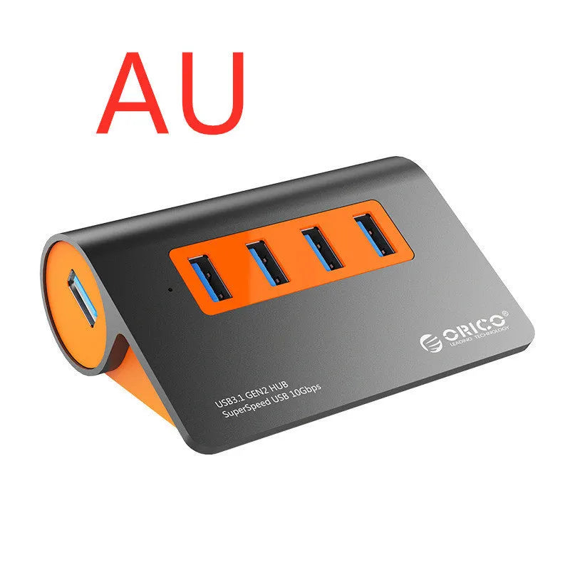 Dark grey aluminium USB hub with orange accents showing four USB 3.1 ports and separate data cable