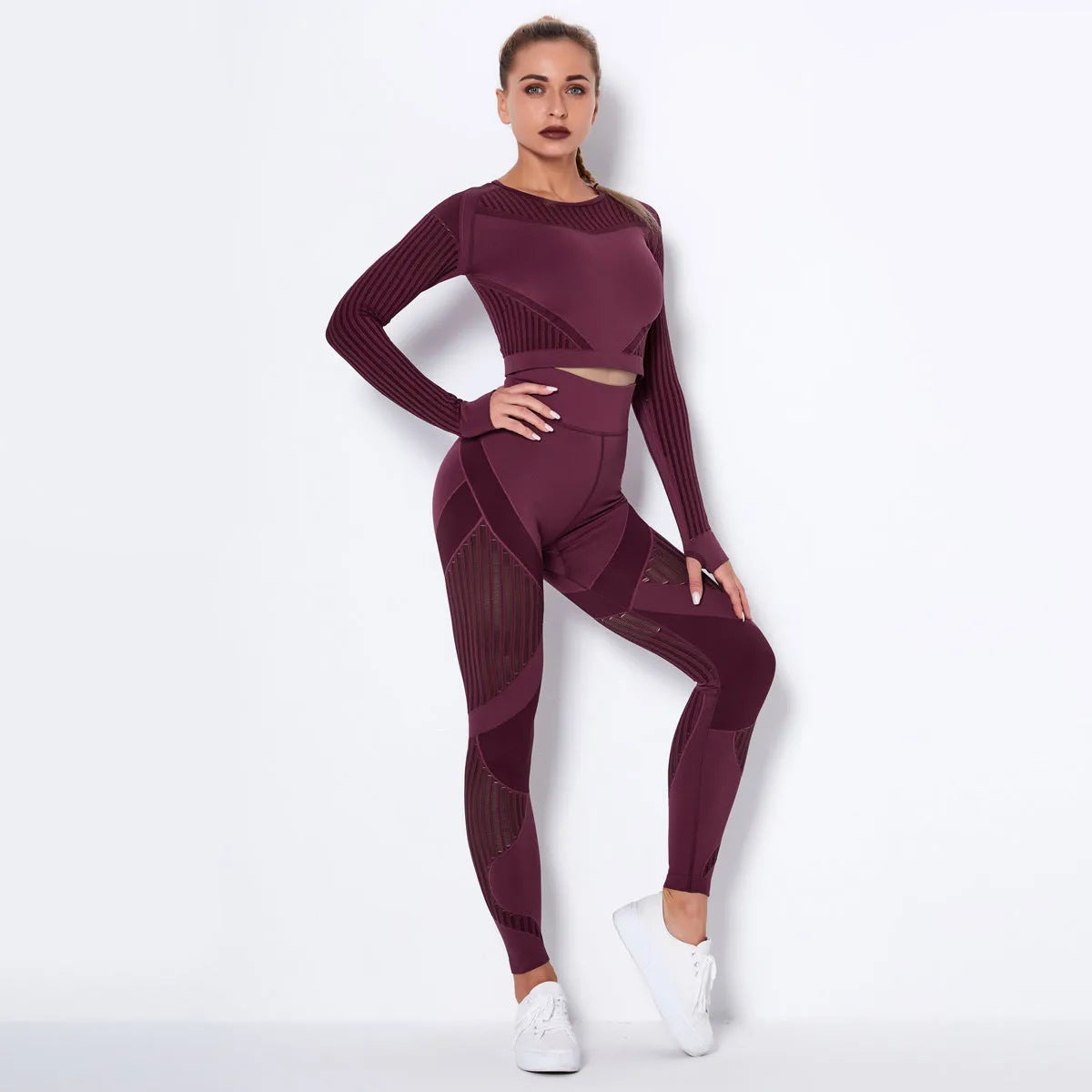 Woman wearing a seamless long-sleeved yoga suit in a neutral colour, demonstrating a stretch pose.