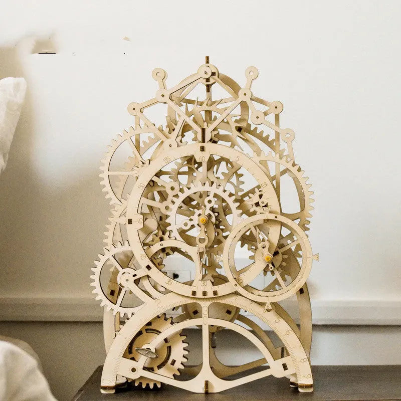 Flat-packed wooden 3D puzzle film projector with visible gear wheel assembly and hand crank