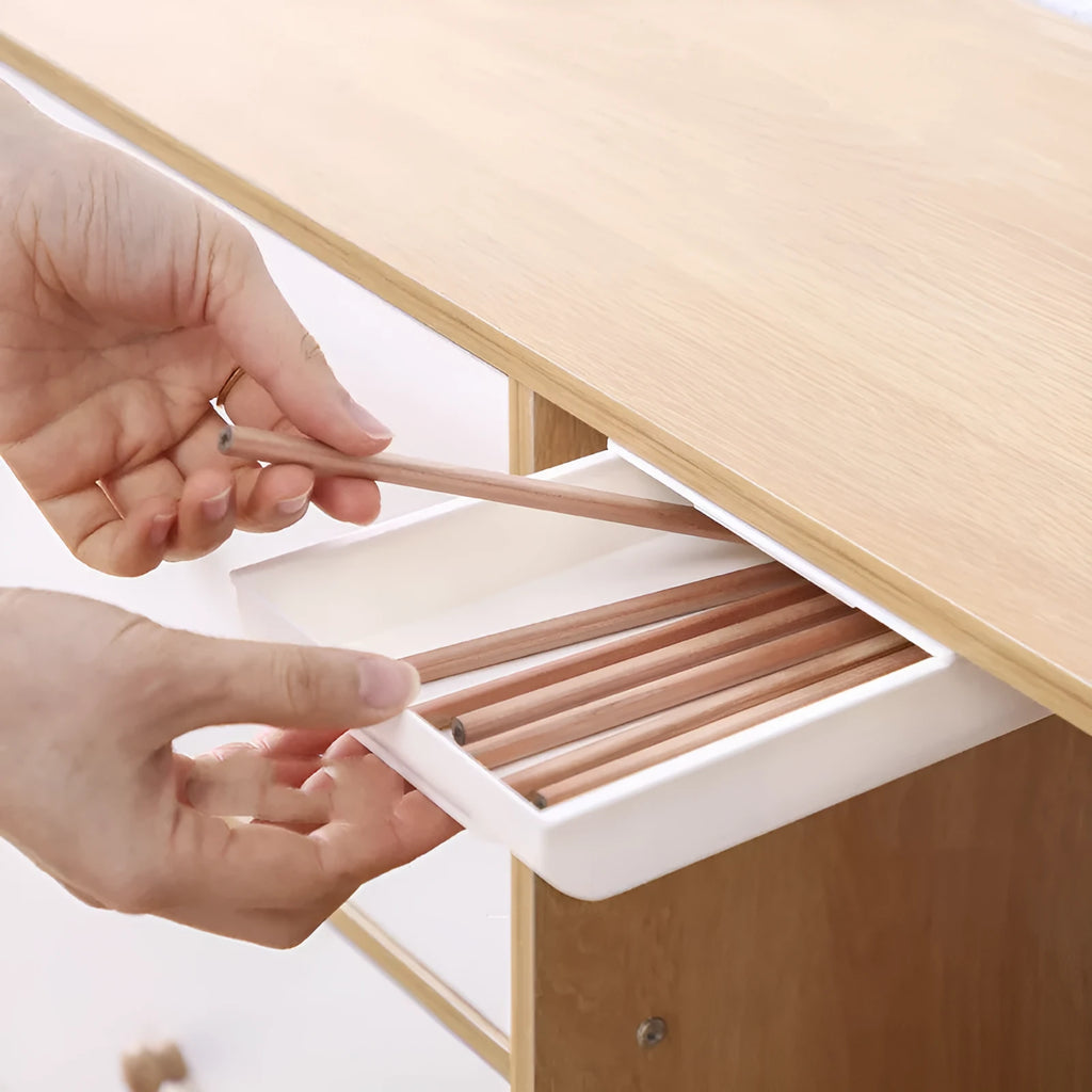 Grey plastic under table storage drawer box for organising stationery in a study.