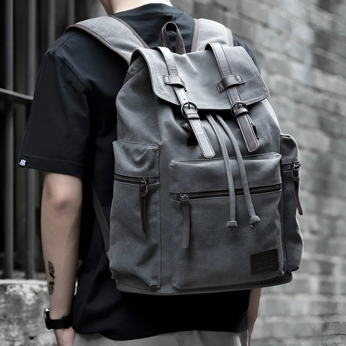 Men's retro canvas backpack in grey with colour-contrast design, large 20L capacity, soft handle, and zipper pocket