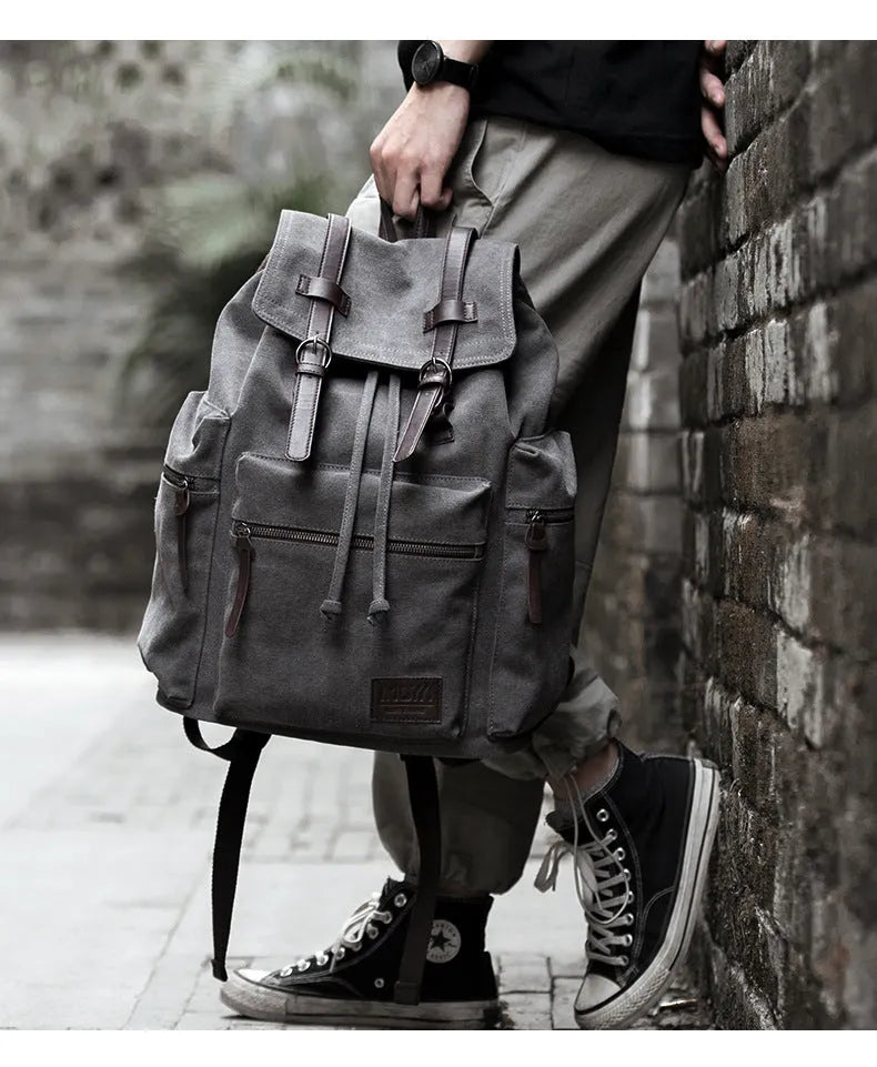 Men's retro canvas backpack in grey with colour-contrast design, large 20L capacity, soft handle, and zipper pocket