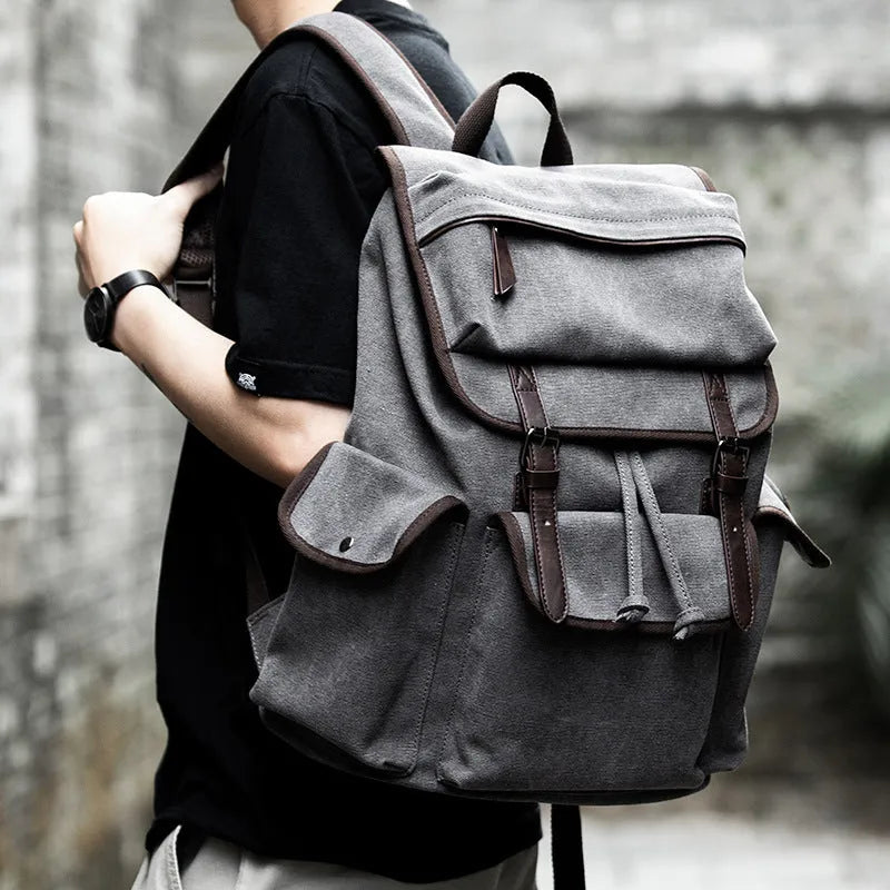 Men's retro canvas backpack in grey with colour-contrast design, large 20L capacity, soft handle, and zipper pocket