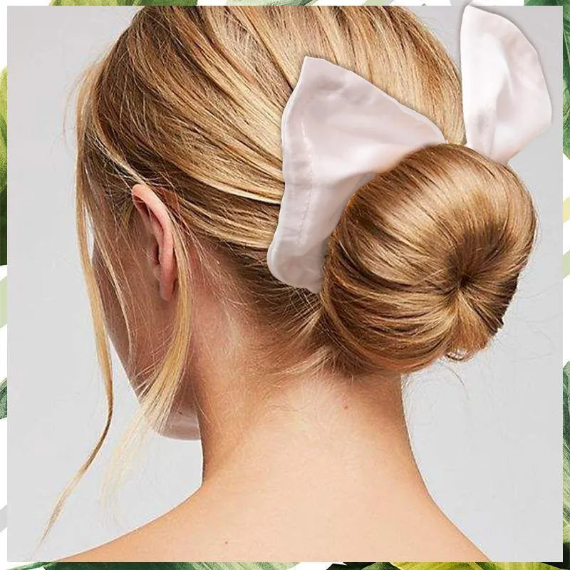 A women's cotton headband with a bowknot style in a natural colour, shown laid flat.