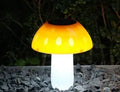 Single solar-powered mushroom garden light with ground spike in white or warm light.