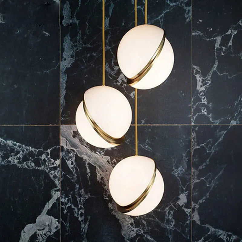 Nordic pendant light with white ball lampshade and golden fixture at adjustable height