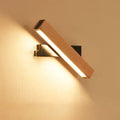 Modern wooden LED wall lamp with adjustable light bar in black finish illuminating room