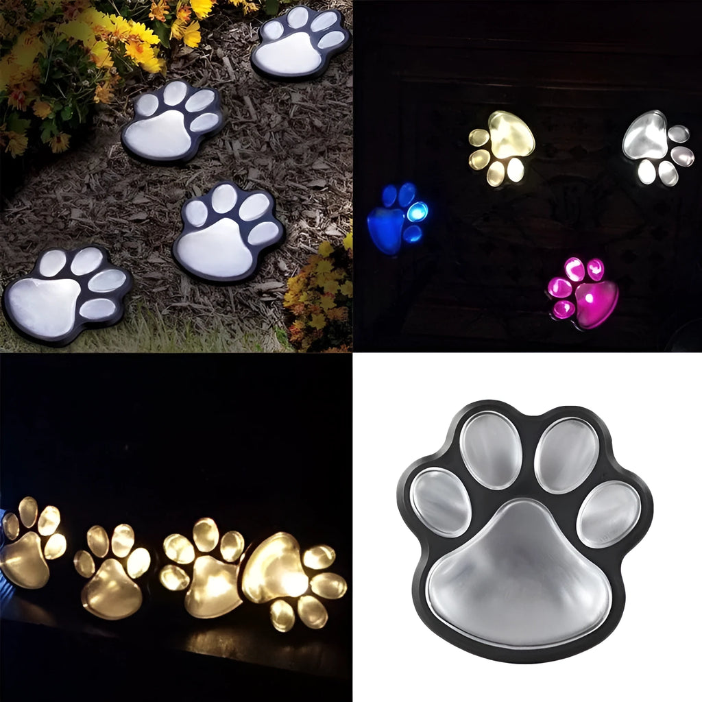 Black solar powered bear paw print garden lights with four paw design on grass