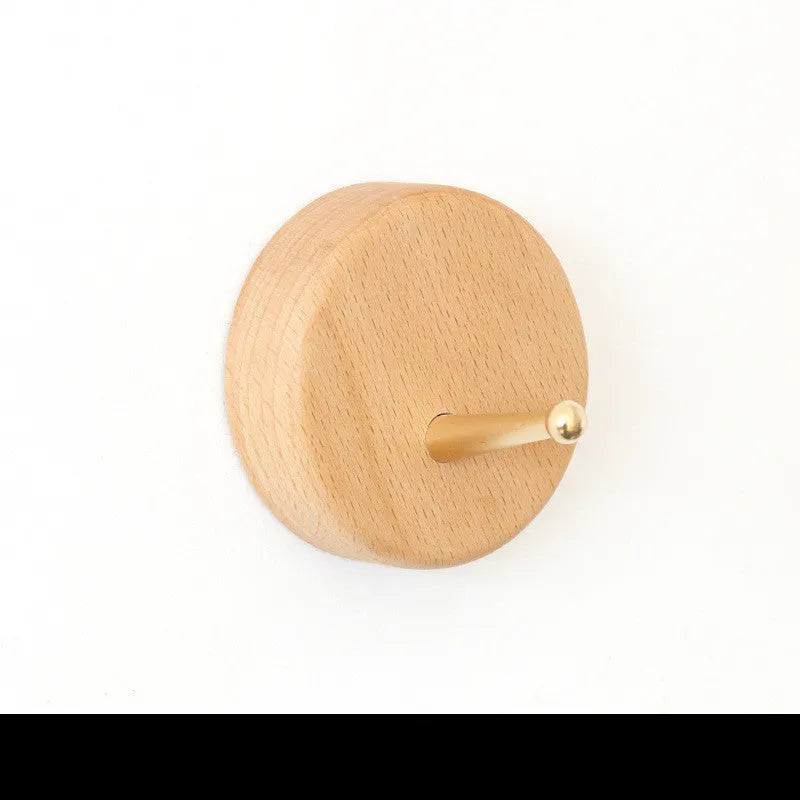 Beech wood and brass adhesive wall hook with a 10kg load capacity in a square shape.