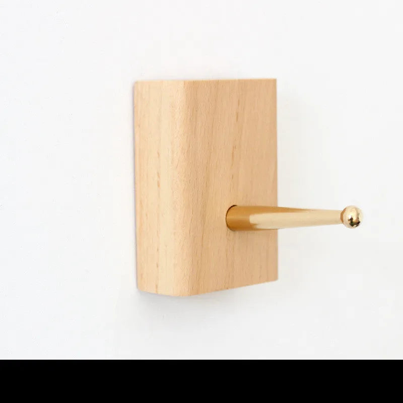 Beech wood adhesive wall hook in brass finish with 10kg capacity and geometric shape options