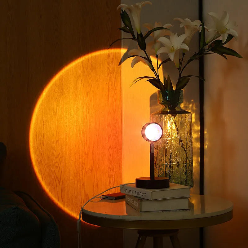 Black USB dual-head sunset rainbow projection table lamp with touch control on bedside table