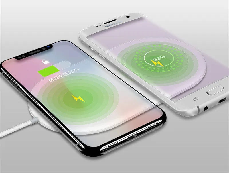 White dual wireless charger for two mobile phones on a table.