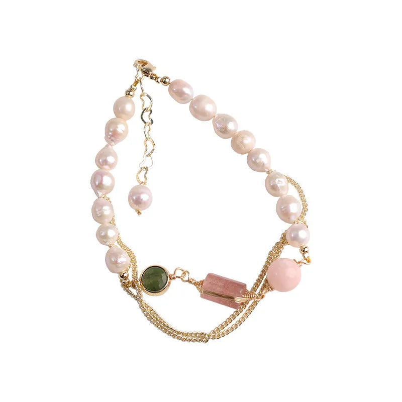 Geometric pink bracelet with natural freshwater pearls and strawberry crystals on a white background.