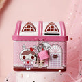 Blue house-shaped tinplate piggy bank with coin slot on desktop