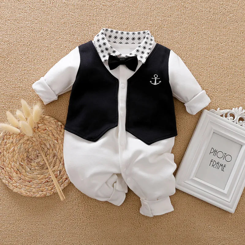 Baby boy wearing a long-sleeved gentleman-style cotton romper in a neutral colour.