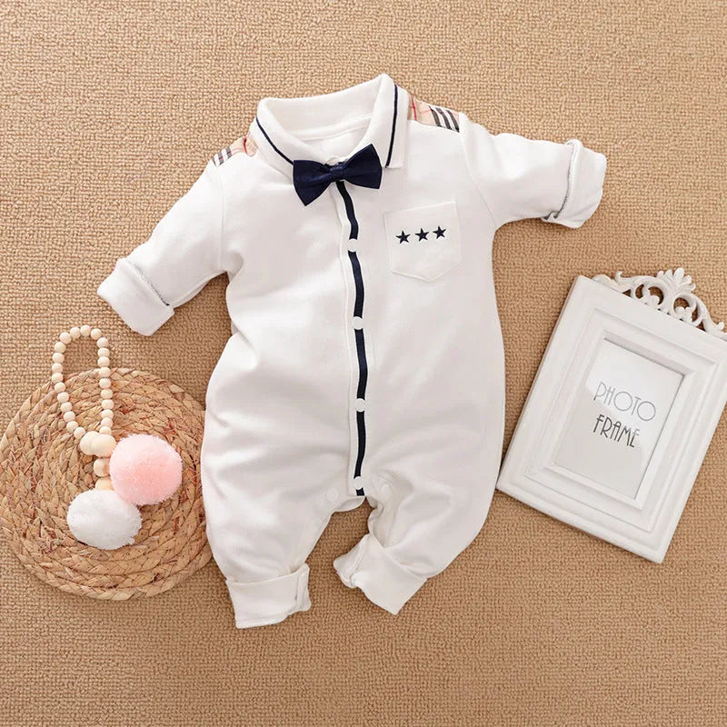 Baby boy wearing a long-sleeved gentleman-style cotton romper in a neutral colour.