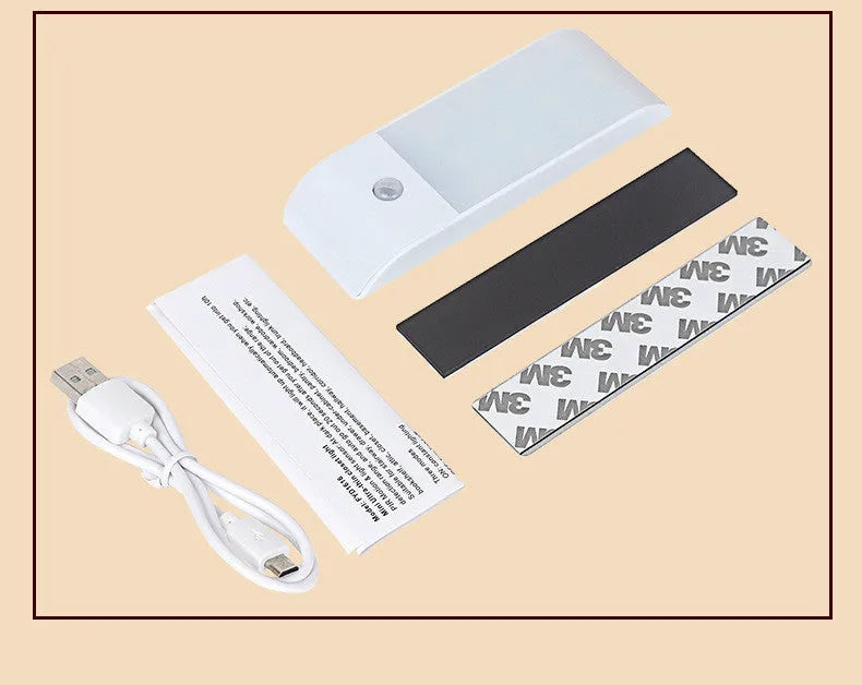 White rechargeable human body sensor LED night light with PVC shade on a cabinet.