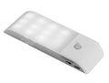 White rechargeable human body sensor LED night light with PVC shade on a cabinet.