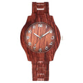 Retro-style quartz watch with brown wood grain dial on a beige silicone strap, showing the folding buckle.