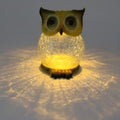 White solar owl garden light with realistic detailing and LED illumination for outdoor placement
