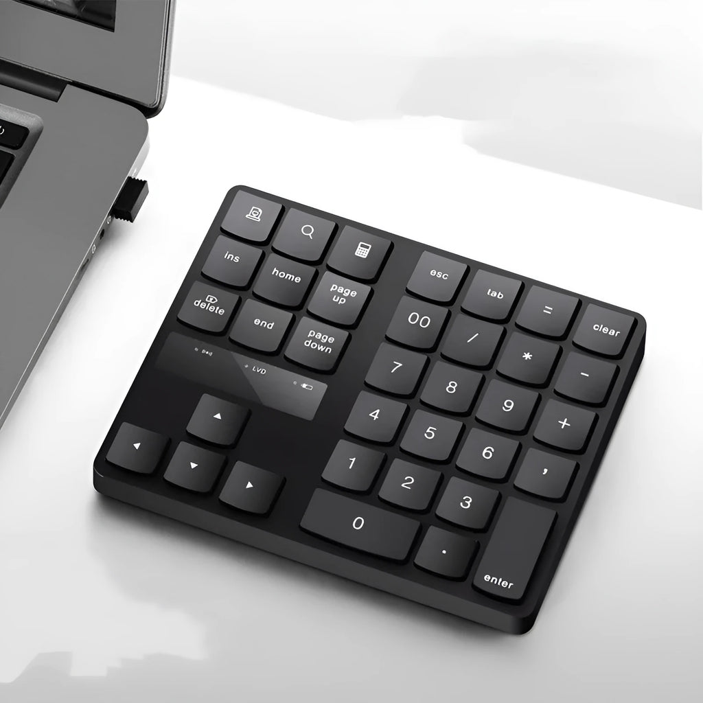 Black wireless numeric keyboard with 35 keys on a desk