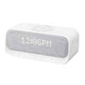 White Anker Soundcore Bluetooth speaker with wireless charging dock and digital alarm clock display.