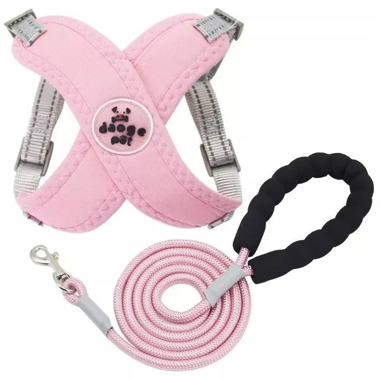 A blue polyester dog vest harness connected to a matching hand-held leash.