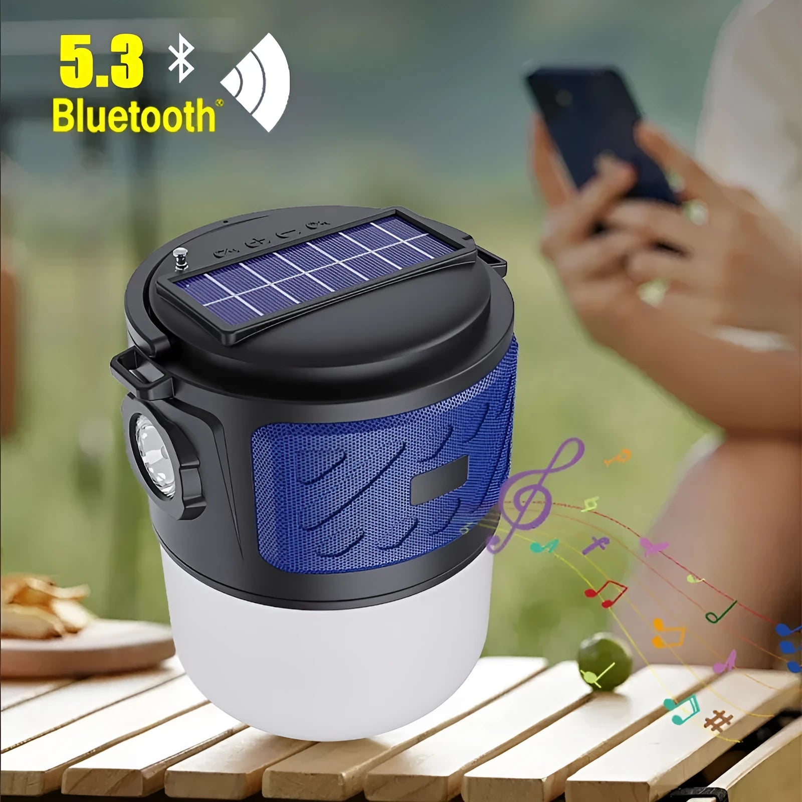 Portable solar camping lantern speaker with Bluetooth, LED light, USB rechargeable, black colour, on outdoor lawn