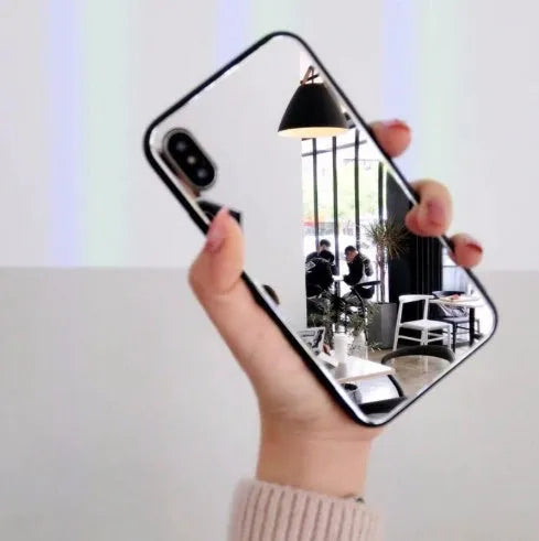 Black iPhone back cover case with a reflective mirror surface and self-timer function.