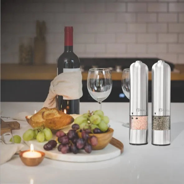Stainless steel electric pepper grinder on a kitchen countertop.