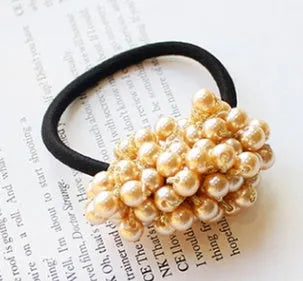Beaded hair rope in black colour on a white background showing the cloth rope with beads along its length.