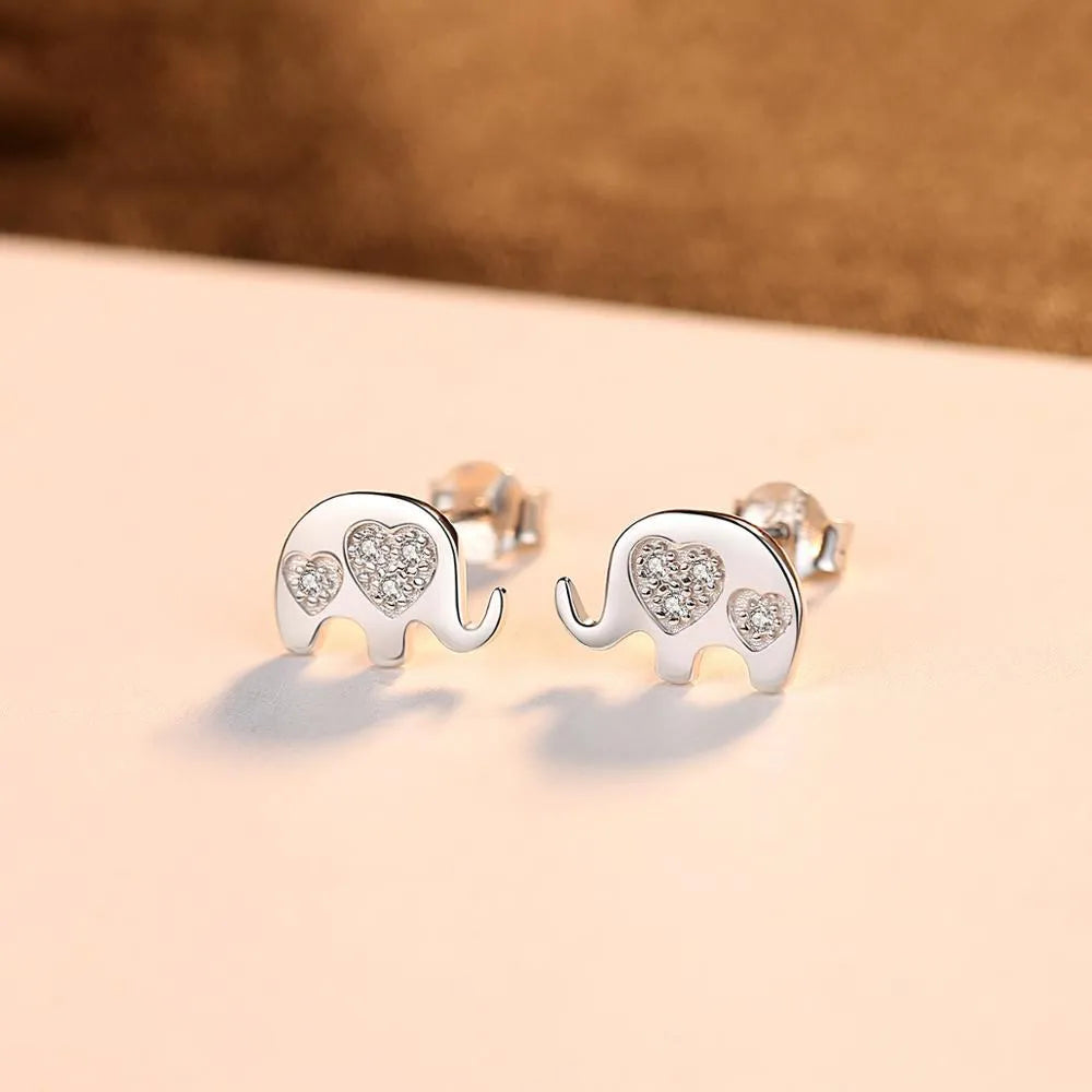 Geometric shaped silver earrings with gem setting, shown in gold and silvery finishes.