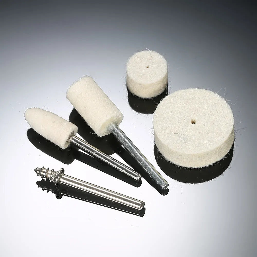 129 piece polishing wheel kit with white wool brushes and metal handles on a table