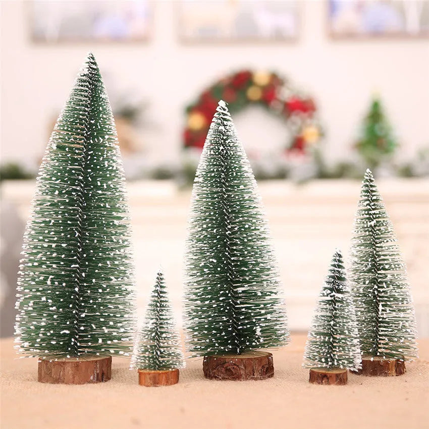 Set of artificial Christmas pine needle trees in green and white, heights 10cm to 30cm, on a tabletop