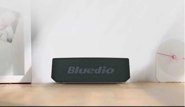Black rectangular smart speaker with AI voice assistant, showing front grille and micro-USB port.