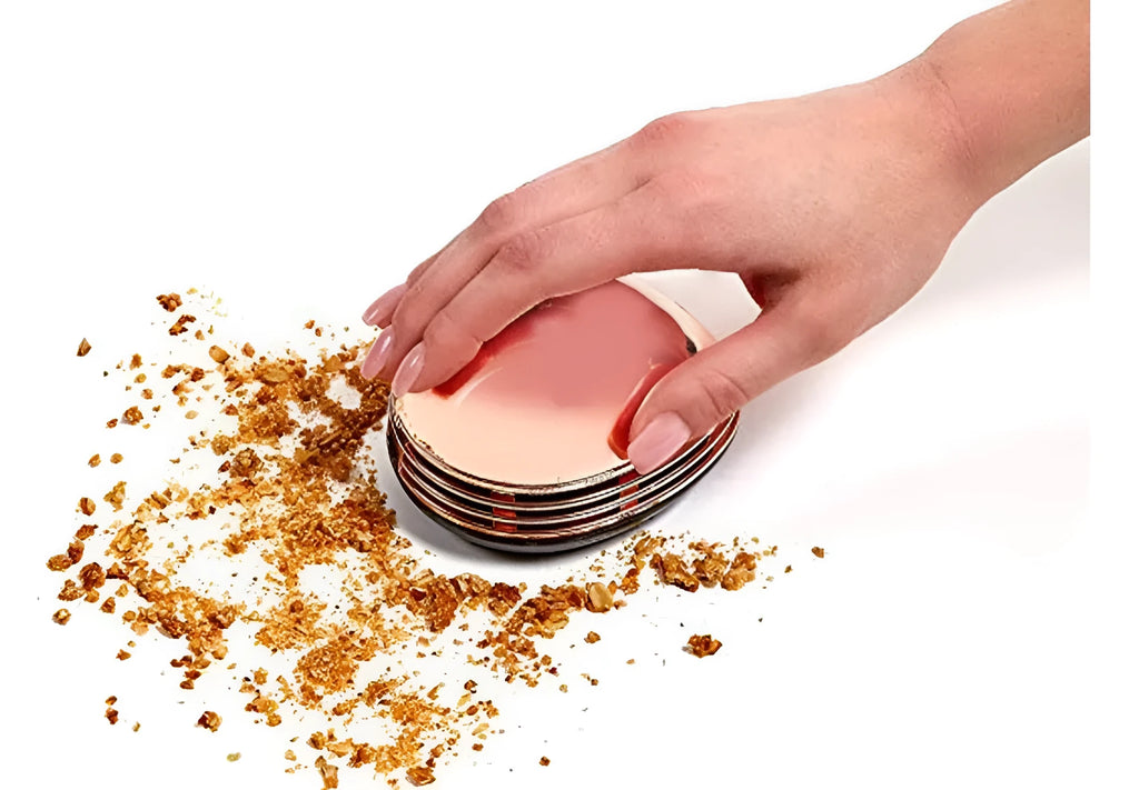 Gold portable mini desktop vacuum cleaner 18x12x10 cm on a wooden desk