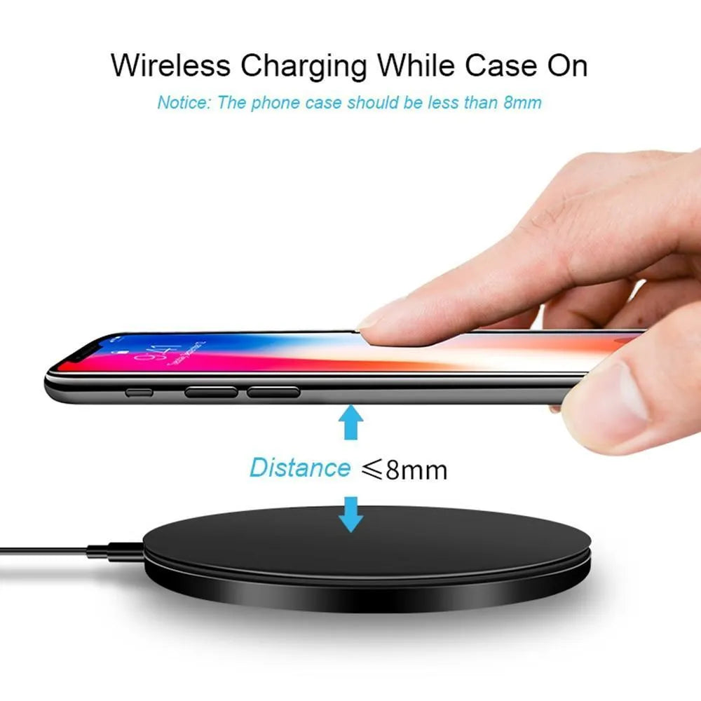 Ultra-thin black wireless charging pad with USB cable on desk