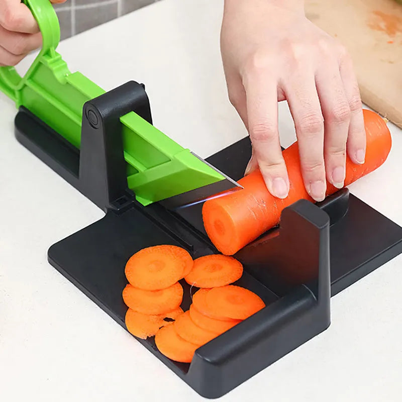 Green kitchen vegetable cutter with stainless steel blades for cutting carrots and potatoes
