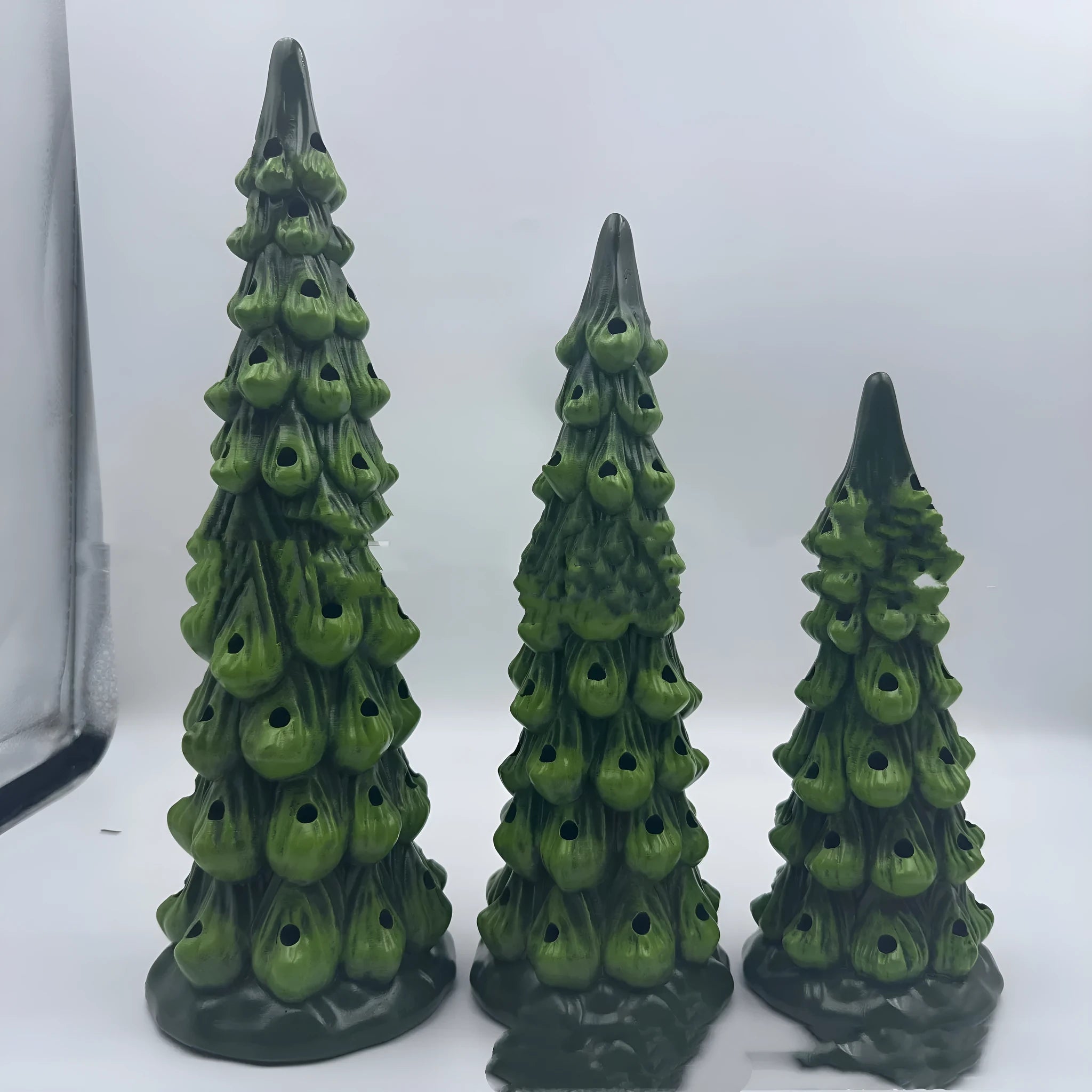 European-style resin Christmas tree decoration in various sizes with coloured or warm lighting options.