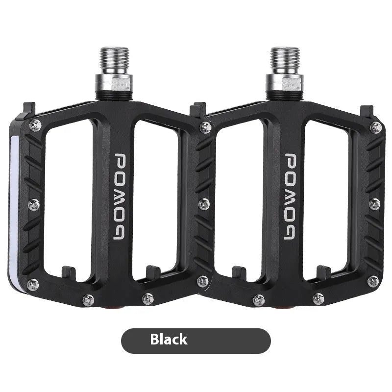 Aluminium alloy bicycle pedals with built-in 710LED lights in black, gold, purple, red, and titanium colour options.
