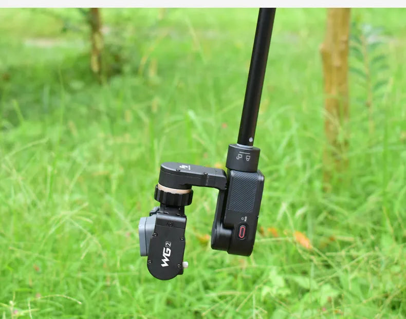 Black retractable selfie stick with handheld stabilizer grip extended for smartphone photography