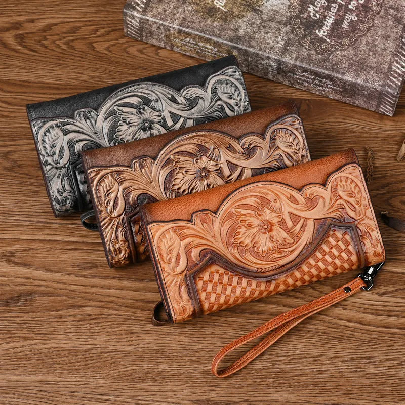 Women's embossed floral tri-fold leather wallet in retro brown colour showing cowhide texture and organisational compartments.