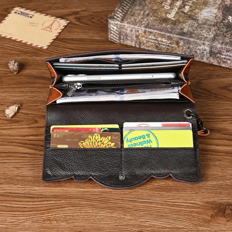 Women's embossed floral tri-fold leather wallet in retro brown colour showing cowhide texture and organisational compartments.