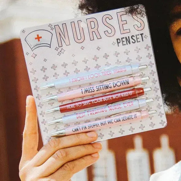 Five blue retractable ballpoint pens with white nurse-themed text, laid side by side.