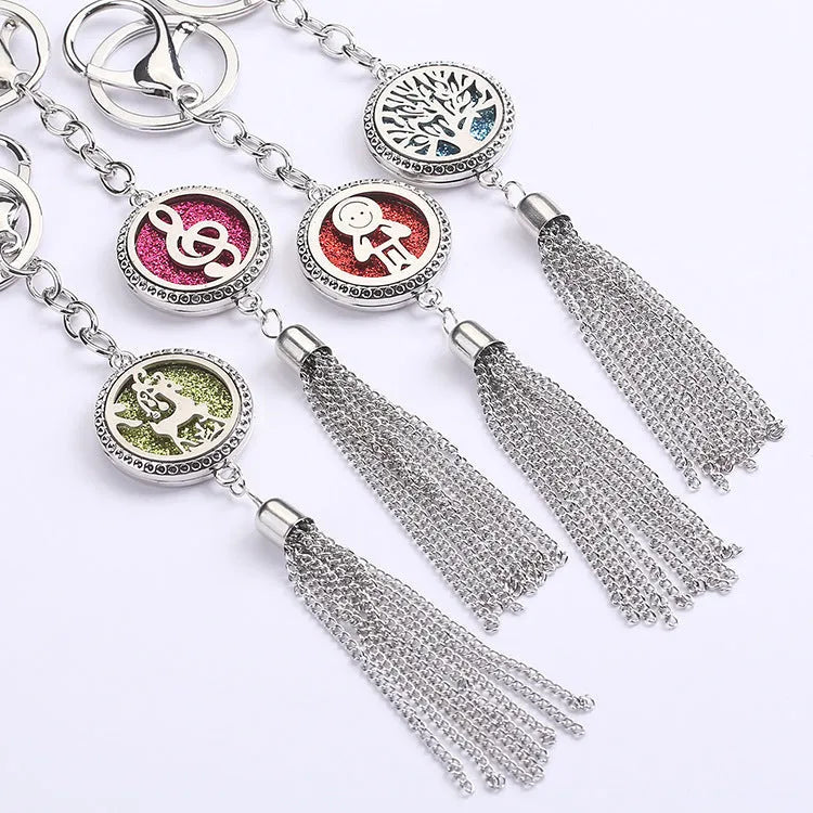 Alloy metal car fragrance pendant with tassel on a 50cm chain, shown with scented cotton pieces.