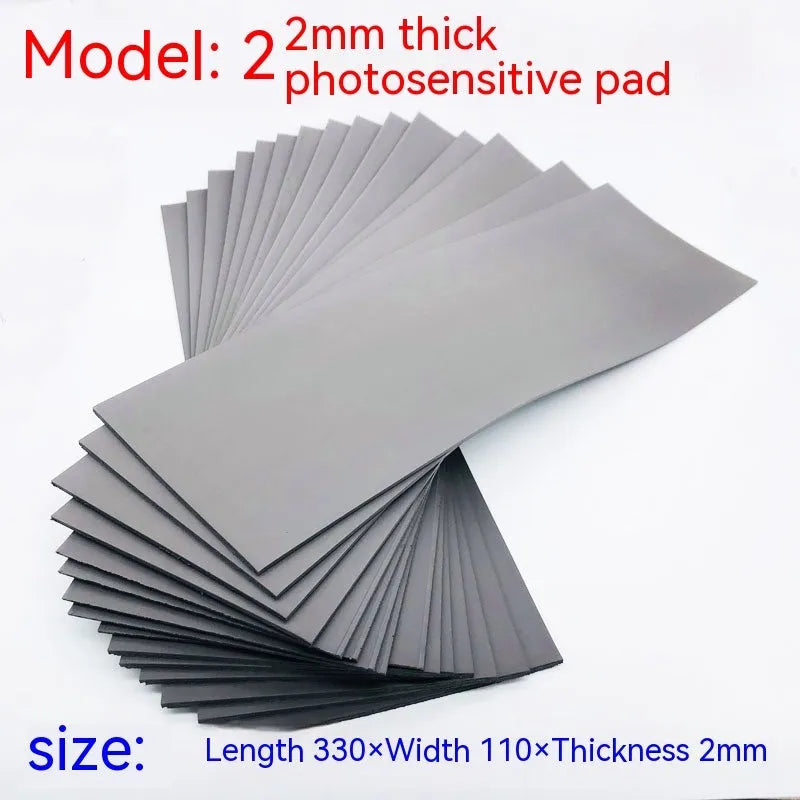 Black and grey plastic photosensitive mat for seal making, shown with dimensions 330mm by 110mm.