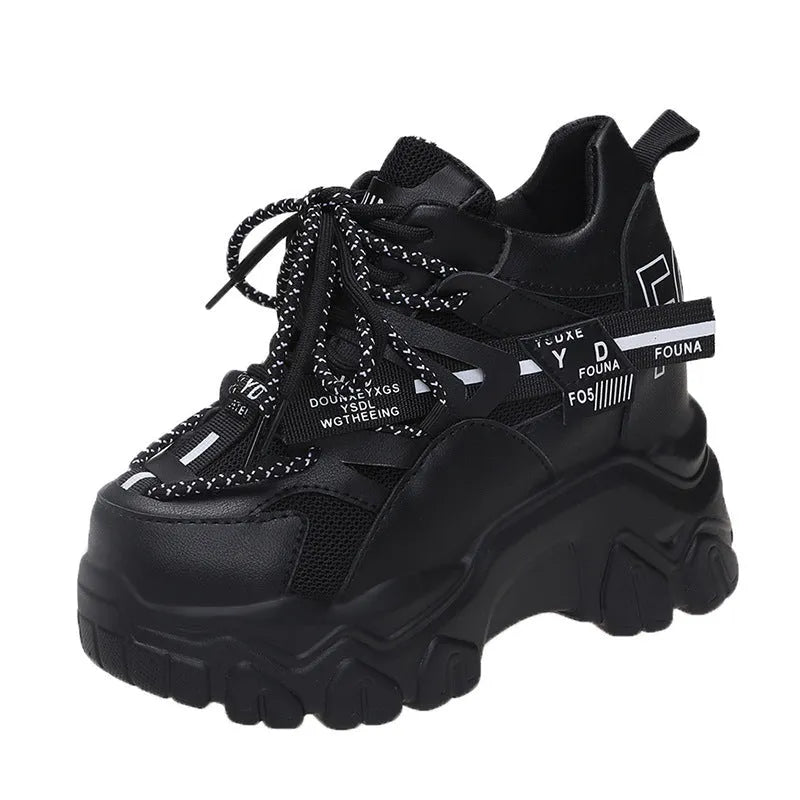 Women's white and black mesh platform sports shoes with cross strap and rubber sole.